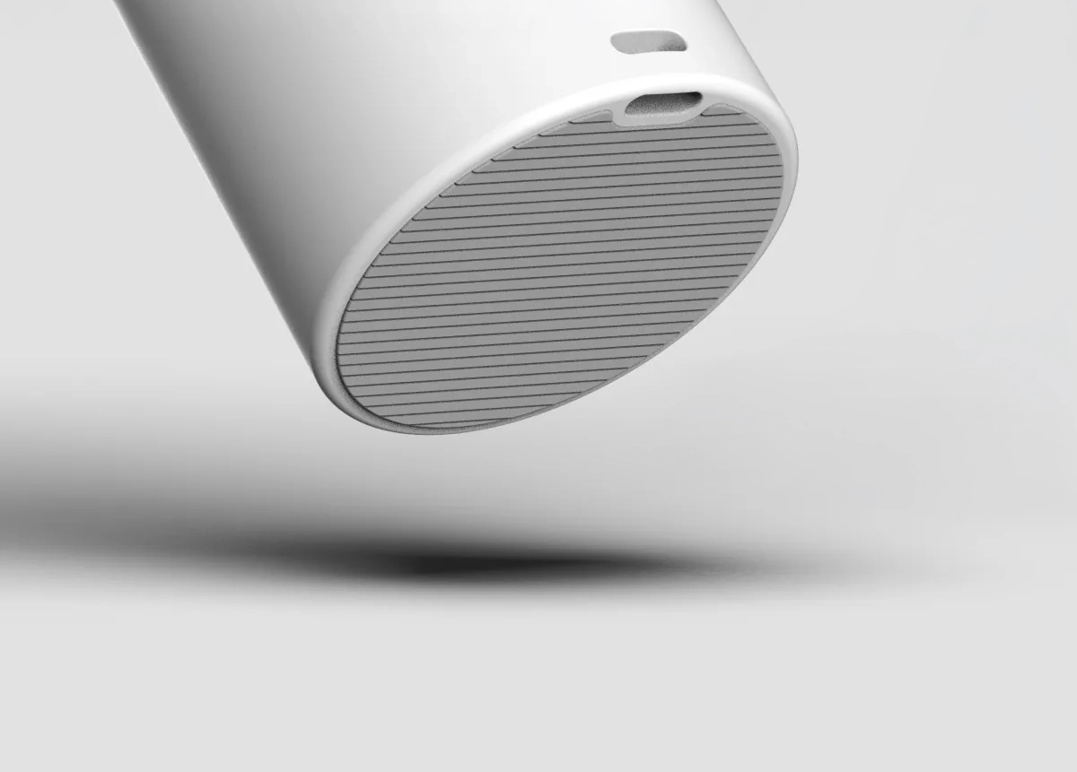 Underside of the handle with the grooved rubber pad and the strap hole